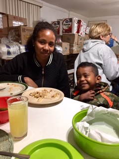 A mother and son from Honduras enjoying a hot meal at CAME after a long journey.