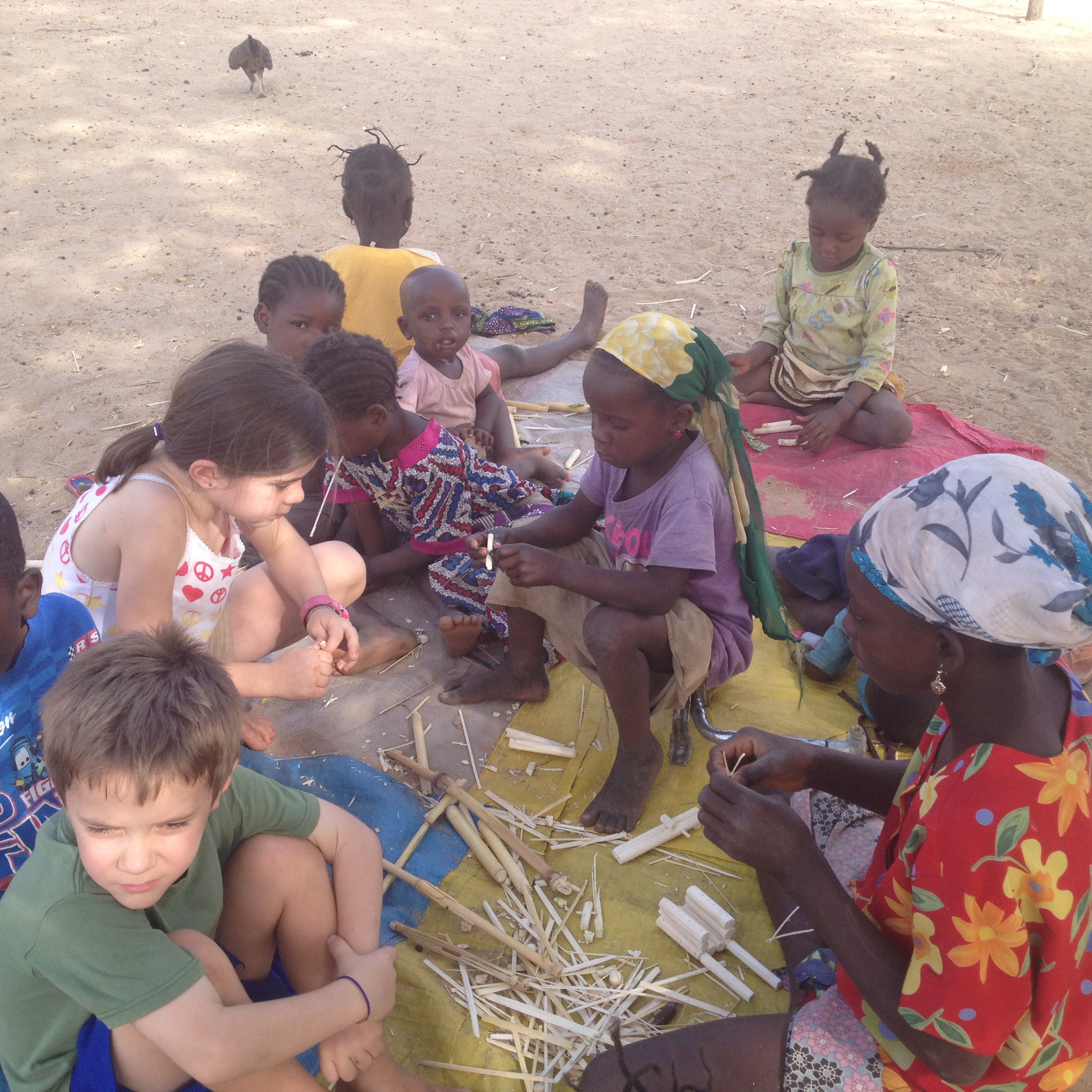 Children at the Bible school building wagons and dolls out of millet stalks