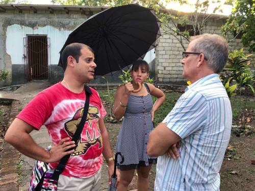 Reile Marrero (left) talks with Ary Fernandez, moderator of the Presbyterian Reformed Church in Cuba, outside hurricane-damaged buildings at CANIP. (Photo by Randy Hobson)
