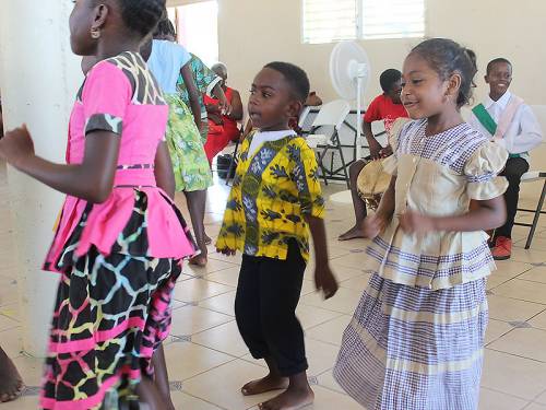 Children from a Hopkins Village school end the day of celebration by performing for SDOP committee members. (Photo by Rick Jones)