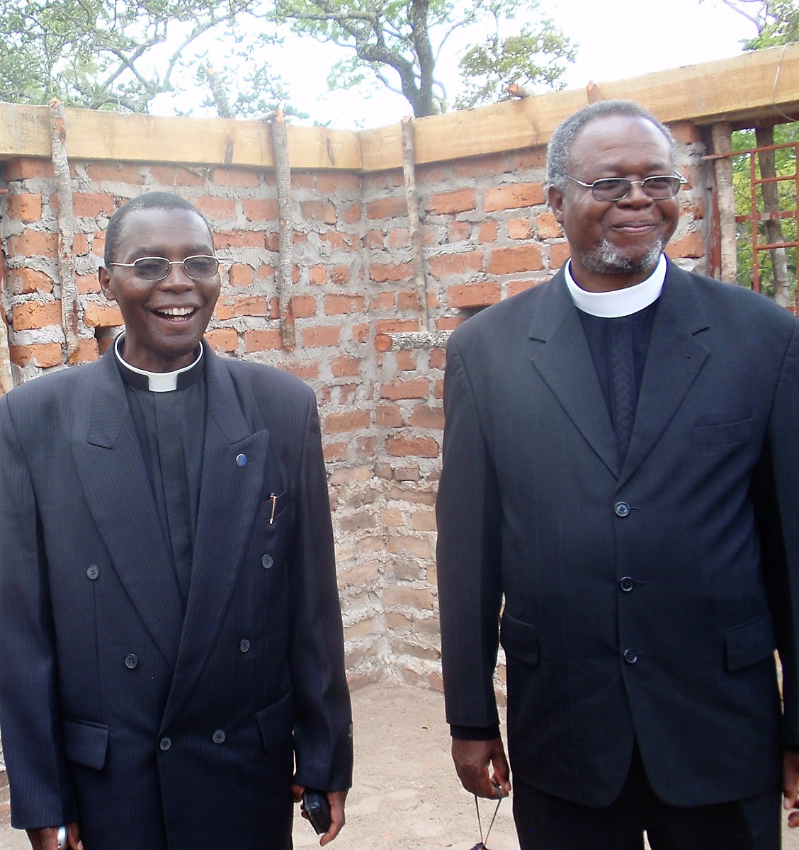 Dr. Chilenje with Rev. David Chiboboka in 2012 in a building under construction at CCAP Zambia’s Chasefu Theological College.