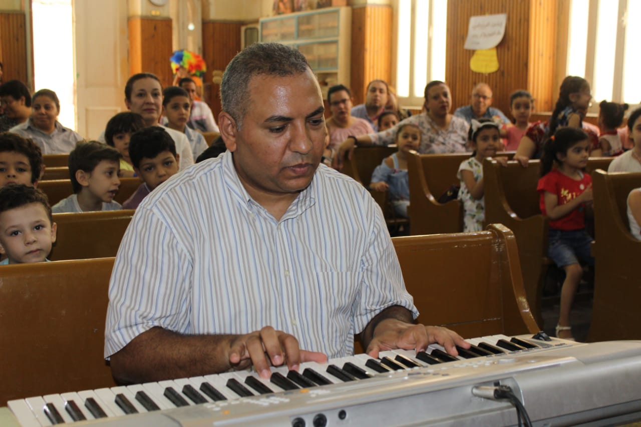 Nazmy playing the piano at Sunday school.