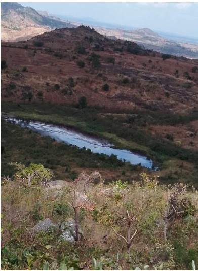 When the mountain had trees, we used to drink water from it the whole year. But today, we only receive water from the mountain in the rainy season. This dam has been filled up by soil due to erosion. (Photo credit: Reuben Kachipapa)