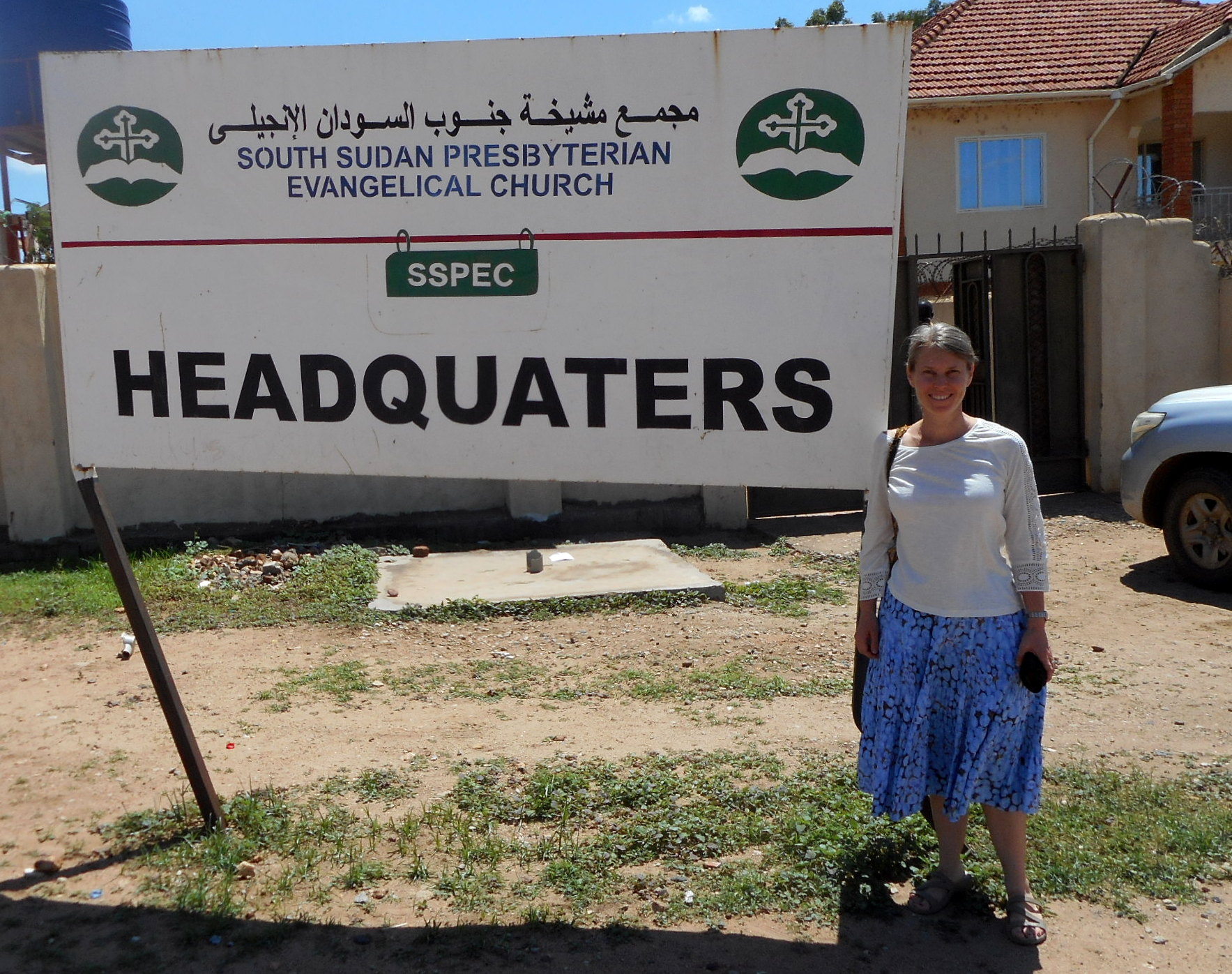 Kristi in front of SSPEC Headquarters, Juba.