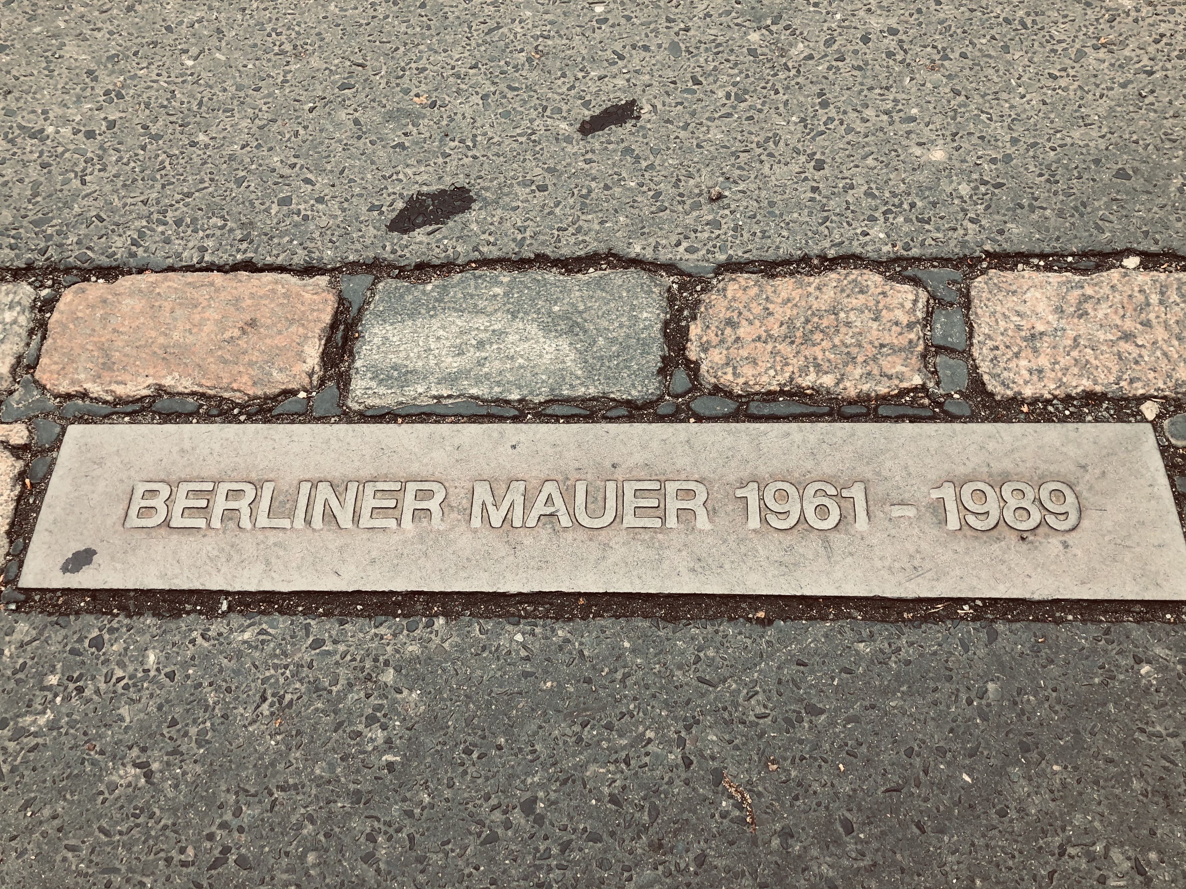 The plaque commemorating the Berlin wall stood along the double brick line from 1961-1989.
