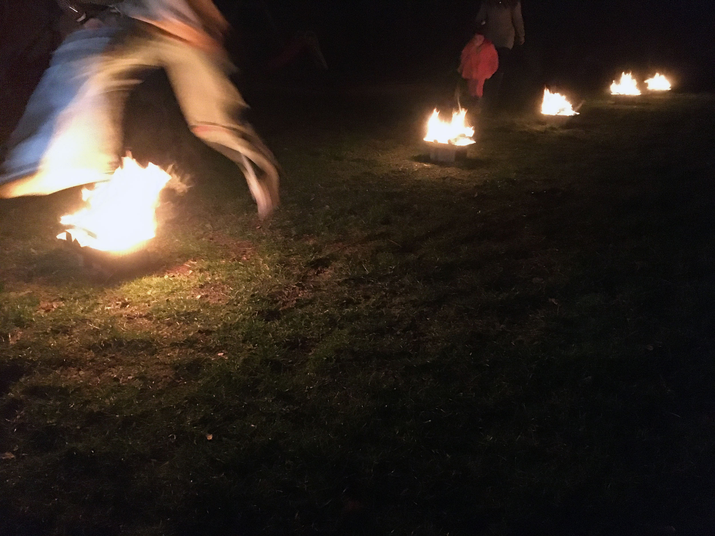A person jumping over the series of fires at the Chaharshanbe Suri celebration. (Photo: Ryan White)