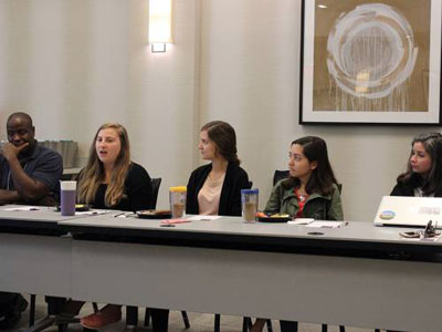 A group of Young Adult Volunteers joins Michelle Muniz-Vega (right) of DOOR Miami to address the SDOP National Committee. DOOR Miami is a faith-based organization providing service, learning and leadership development within the urban context. (Photo by Rick Jones)