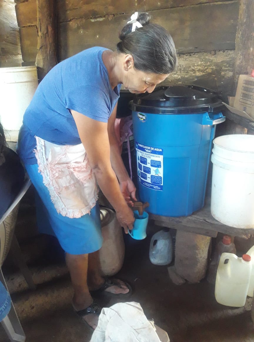 The beneficiary of a water filter provided by CEPAD.