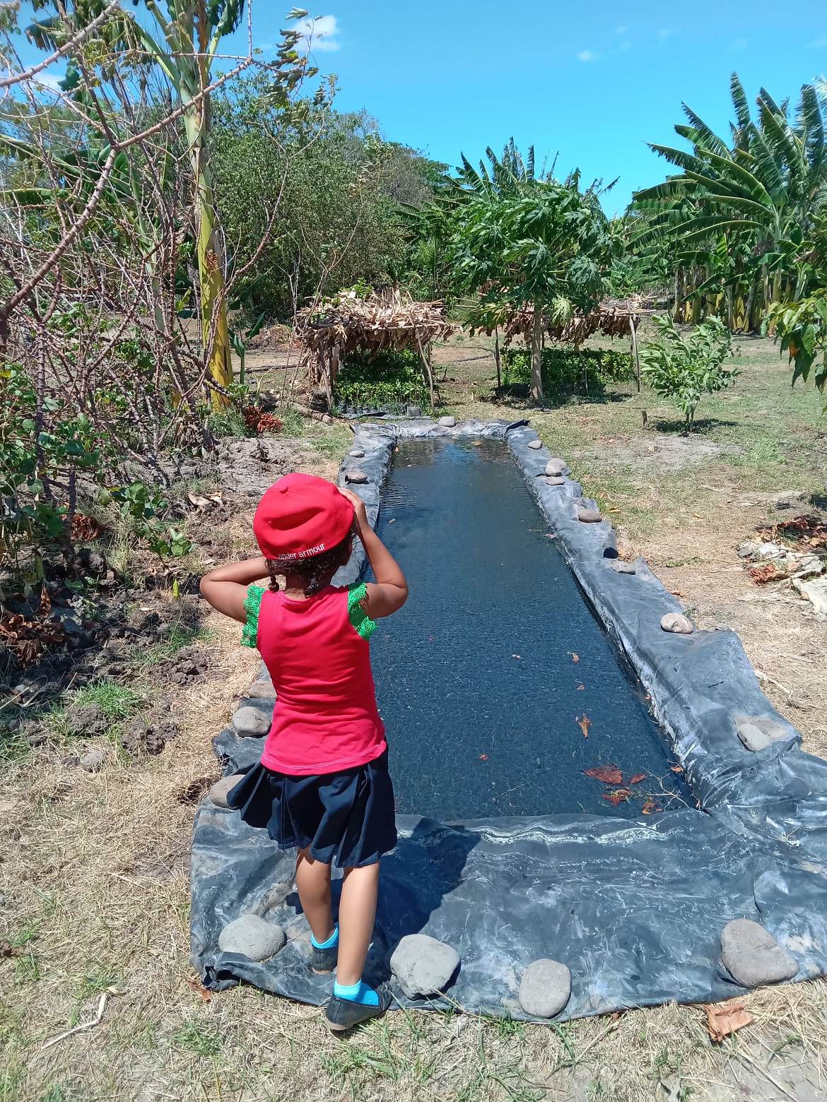 Little girl admiring a water reservoir (La Montañita)