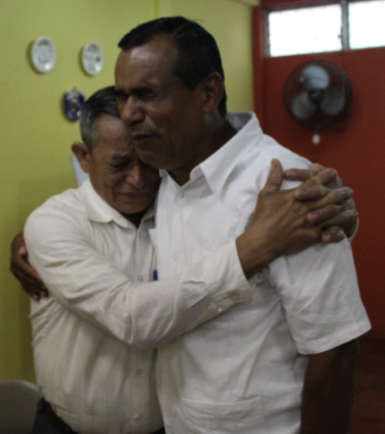 Nicaraguan pastors pray for each other during crisis training.