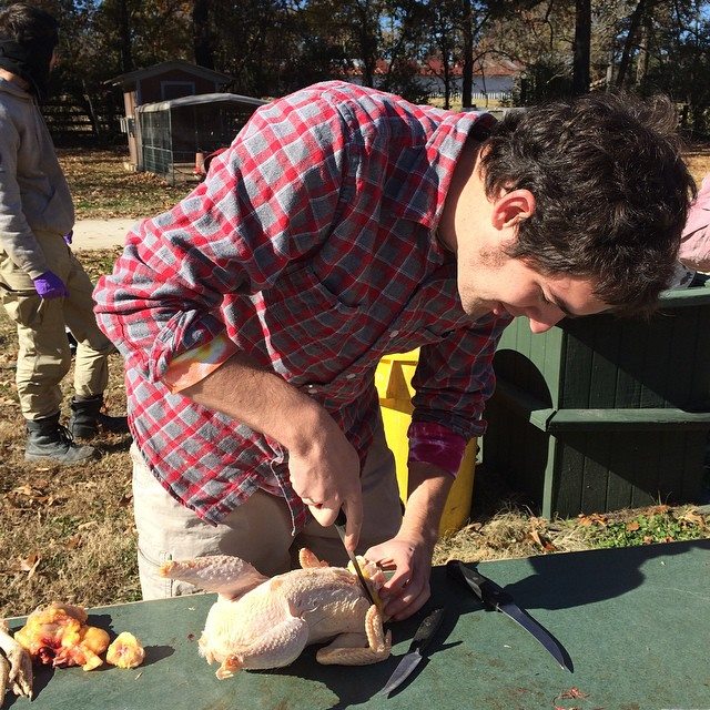 Picture of me removing the chicken's crop and cutting the organs away from the neck bone. Photo taken by Molly DeWitt, Copywrite 2014