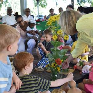 kids and adults with flowers in a worship service