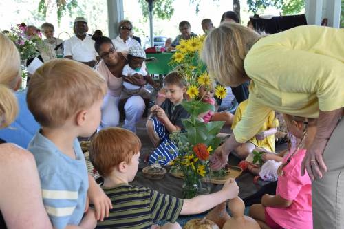 kids and adults with flowers in a worship service