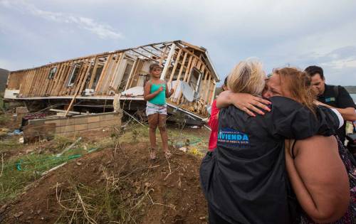 family comforted w wrecked house