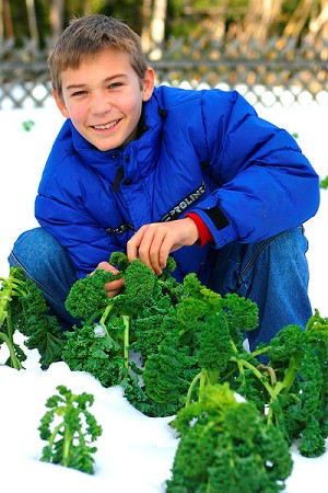 boy with kale in the snow