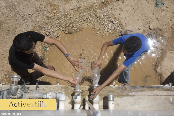 Boys in West Bank filling water bottles