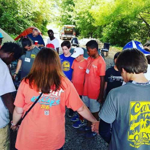 Youth from First Presbyterian Church, Gainesville, Georgia pray before they share a meal with people who are homeless.