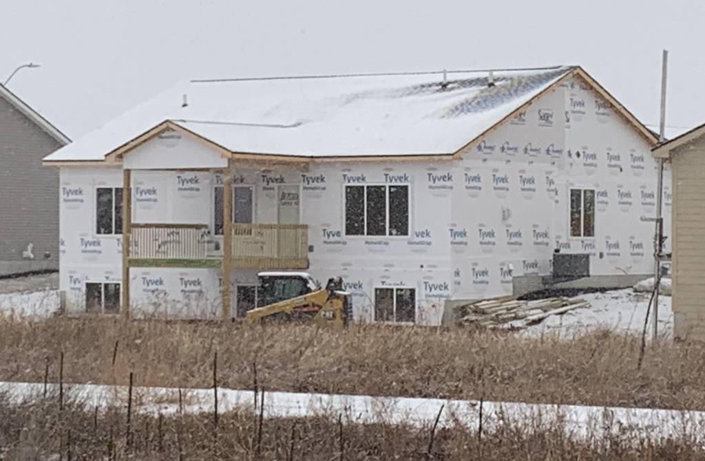 Illustration of bleak mid-winter and house under construction