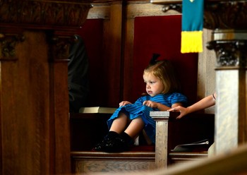 A child listens to the children's sermon at Josh's church