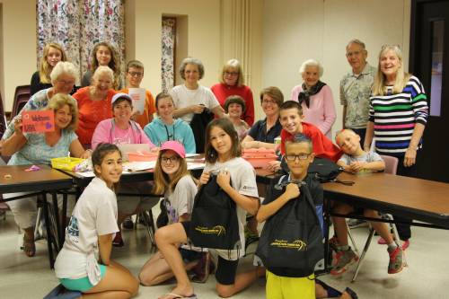 Members of the Derry Presbyterian Church fill backpacks for people who are homeless.