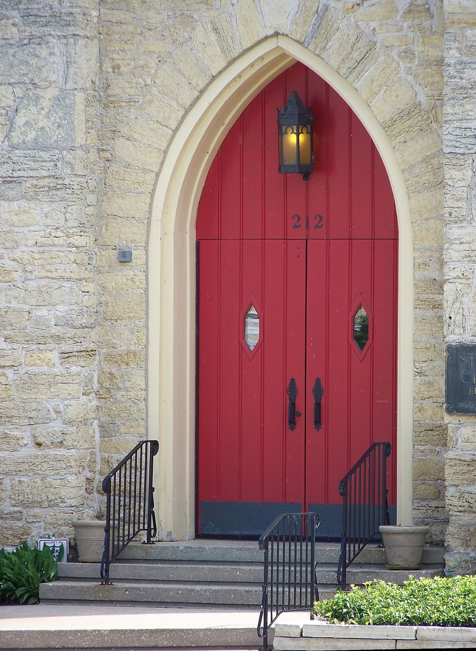 Stone church with red door signaling sanctuary