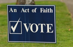A poster saying "An Act of Faith - VOTE"