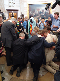 Religious leaders kneel in the Capitol Hill Rotunda to pray for a just and compassionate budget.