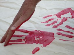 Red hand being made with paint