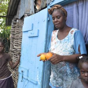 Haitian woman holding oranges