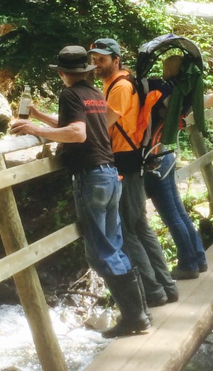 eco-stewards conversing at waterfall