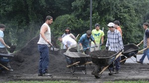 FPC Howard County youth carrying mulch for rain garden